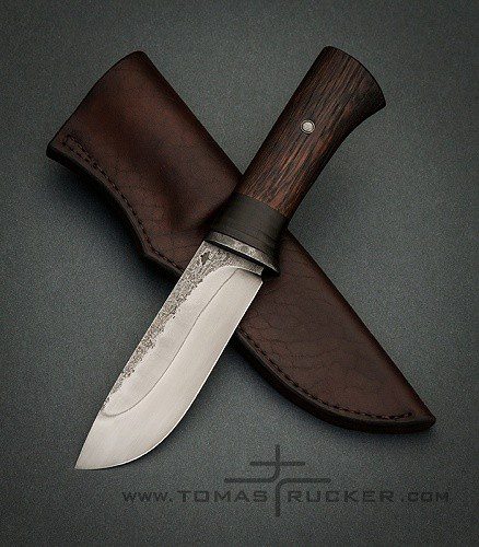 Bushcraft knife with hamon line and dark wood handle by Tomas TRMAN Rucker.