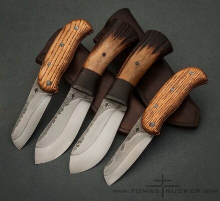 KNIVES by Tomas Rucker Set of two Nessmuk and friction folder knives with hamon lines, oak and antler handles by Tomas Rucker.