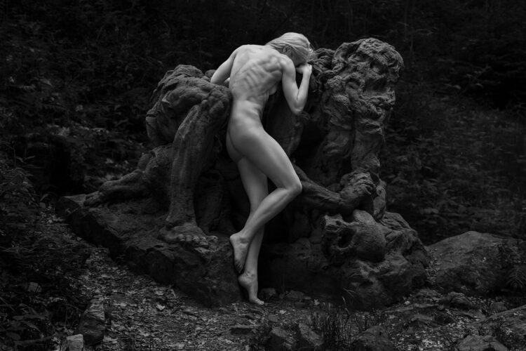 Baroque Dialogue: Human and the Work of Matyas Bernard Braun A dramatic black and white image by Tomas Rucker showing the fusion of a human figure with a baroque sculpture by Matyas Bernard Braun in a natural setting.